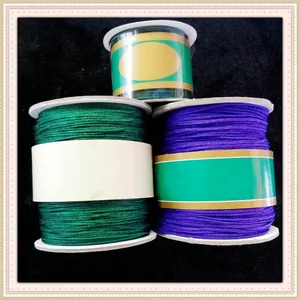 Detailed view of three rolls of high-quality jade thread for DIY jewelry weaving