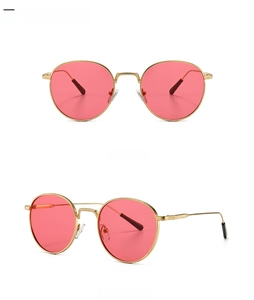 Front and side view of retro round metal sunglasses with gold frames and red lenses