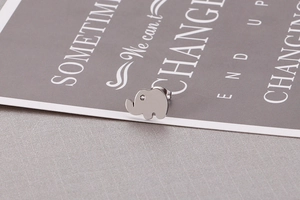 Macro shot of silver elephant stud earring with sparkling cubic zirconia eye detail