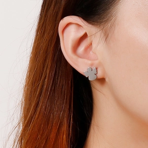 Minimalist stainless steel angel wing stud earrings shown on model for daily wear