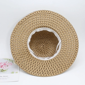 Straw sun hat for women with wide brim and adjustable chin strap on white background
