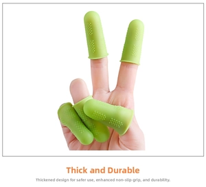 Macro shot of thick green silicone finger protectors with anti-slip texture on hand