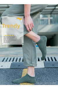 Detail of dark green ribbed knit low-cut socks featuring a trendy Japanese street style