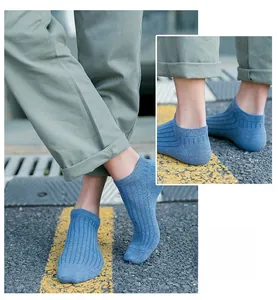 Detail of light blue ribbed cotton blend ankle socks showing the elastic cuff texture