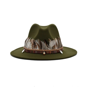 Detail of dark green fedora hat featuring ethnic woven band and authentic feather accent