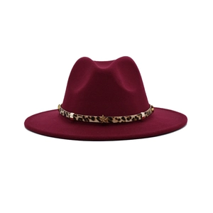 Close-up of wine red wool fedora with leopard print band and gold star studs