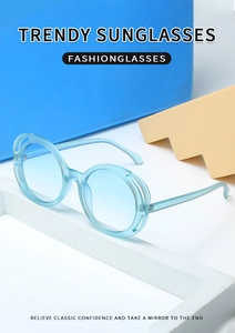 Detail view of round light blue sunglasses featuring a unique double-layer hollow frame design