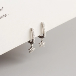 Detail of S925 sterling silver U-shaped hoop earrings with sparkling star charms