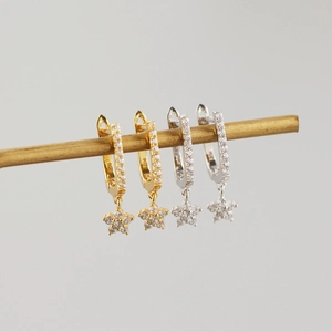 Detailed close-up of S925 silver U-shaped hoop earrings with star charms and pavé zircon