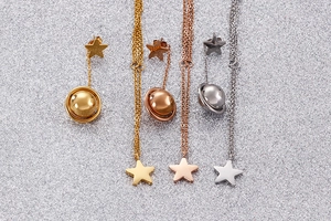 Detailed view of star and steel bead jewelry sets in gold, rose gold, and silver finishes
