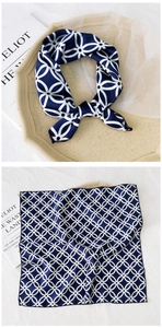 Detailed view of dark blue silk scarf featuring elegant white geometric ring patterns
