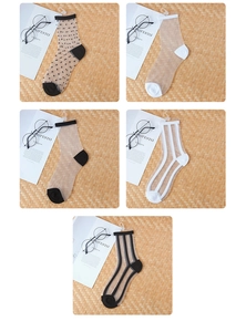 Detailed flat lay of transparent mesh socks with various patterns and polka dots on a woven mat