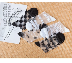 Detail of five pairs of ultra-thin sheer mesh socks with classic patterns and cotton soles
