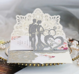 Macro shot of silver glitter Mr & Mrs wedding cake topper with elegant heart design