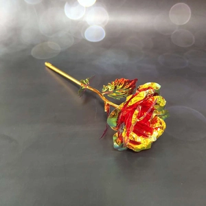 Macro detail of holographic red gold foil rose petal texture with polished golden stem