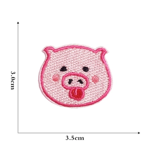 Detailed embroidery texture of pink pig cartoon patch with 3.5cm measurement scale