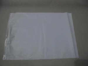 Flat lay of a white translucent waterproof travel storage bag with side zipper closure