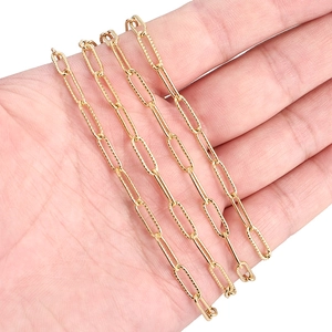 Golden 4mm stainless steel textured oval link chain shown on hand for scale