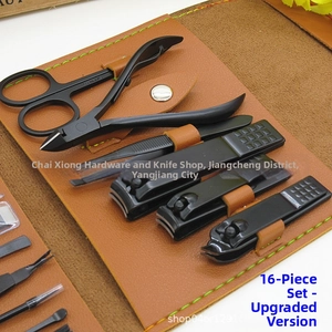 Close-up of 16-piece black matte manicure set in premium brown leather storage case