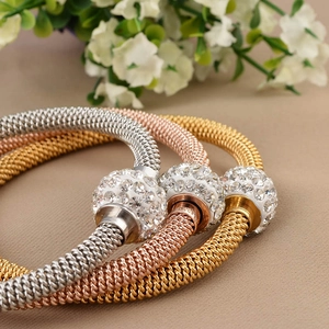 Three mesh weave stainless steel bangles in gold, silver, and rose gold with crystal balls