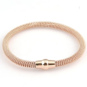 Detail view of rose gold woven cable bracelet featuring a secure magnetic clasp