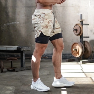 Detail view of desert camo 2-in-1 sports shorts with breathable mesh and black liner