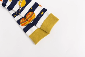 Detail of space-themed crew socks with navy stripes and colorful planet patterns