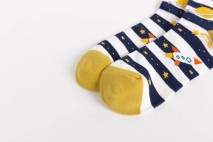 Detail of cotton crew socks with blue stripes and colorful cosmic rocket and planet patterns
