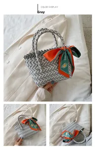 Detail of woven beach tote bag in grey and white with floral silk scarf decoration