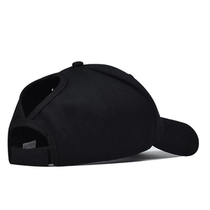 Detail view of the V-shape ponytail opening and adjustable velcro strap on black cotton cap