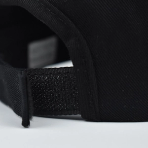 Close-up of black cotton ponytail baseball cap with adjustable Velcro back strap closure
