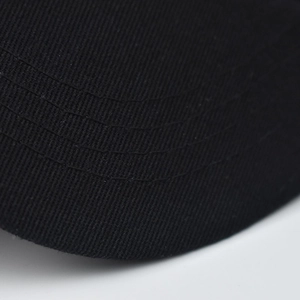 Close-up of black cotton baseball cap brim with durable parallel reinforced stitching
