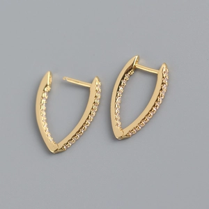 Detailed close-up of V-shaped gold earrings with sparkling pavé cubic zirconia inlay