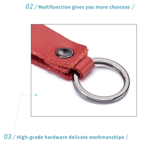 Detail of red genuine leather keychain with black rivet and silver metallic key ring