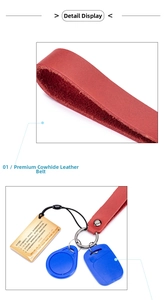 Detail of red genuine leather keychain strap with premium cowhide texture and metal ring