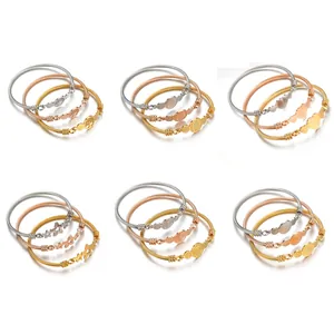 Three-tone stainless steel cable bracelets featuring tree of life and star charms
