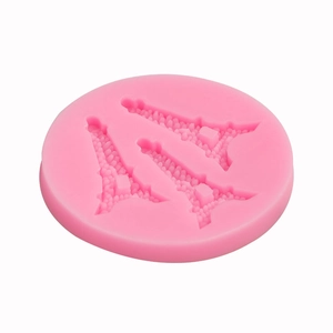 Pink silicone mold with three Eiffel Tower cavities for fondant cake or soap crafting