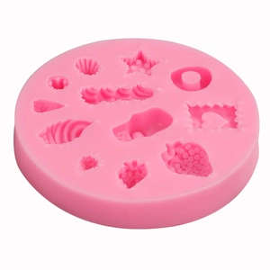 Pink silicone mold featuring strawberry, star, and shell patterns for DIY dessert crafts