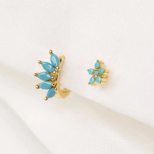 Macro detail of turquoise marquise drop earrings and floral stud in gold finish