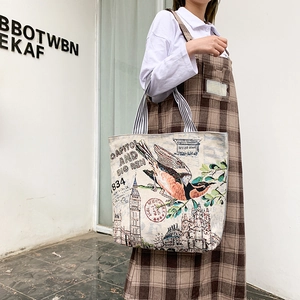 Detail of artistic canvas tote bag featuring Capitol and Big Ben prints and striped handles