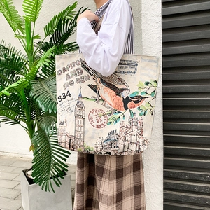 Close-up of printed canvas tote bag featuring retro Big Ben design and vintage stamps