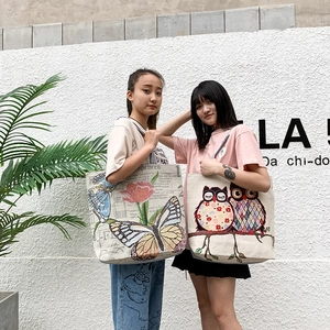 Detailed view of canvas tote bags featuring vintage butterfly and owl print patterns