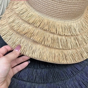 Handmade woven sun hat with multi-layered fringe brim and natural straw texture