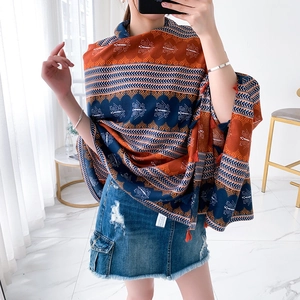 Ethnic cotton linen scarf with blue and orange patterns and tassel details