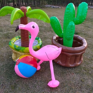Outdoor view of inflatable flamingo, palm tree, cactus and colorful beach ball set