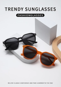 Detail of polygonal sunglasses frame with metal rivets on black and orange temples