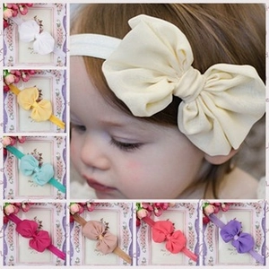 Detail of infant headband set with large fabric bows in multiple vibrant colors