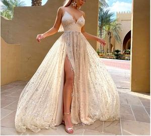 Detail of champagne gold dress with silver star sequins and high waist side slit