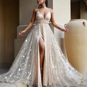 Champagne sequin evening gown with star patterns and high slit in outdoor scene