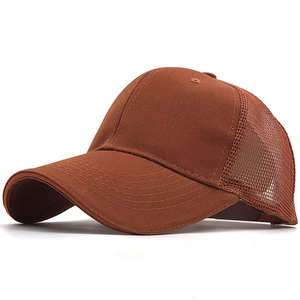 Close-up of a brown breathable mesh trucker hat with solid fabric front and curved brim
